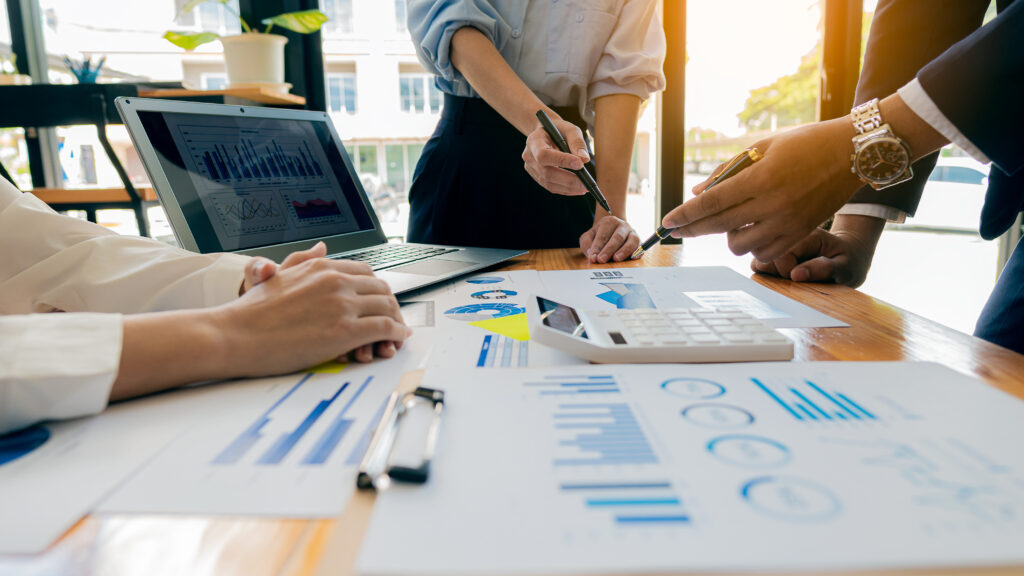 Work with the best agency in social media marketing services and win more customers. Photos shows a diverse group of three sitting together all facing a computer and working collaboratively.